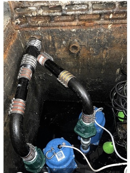 Dual pump assembly with connected piping inside a pump pit